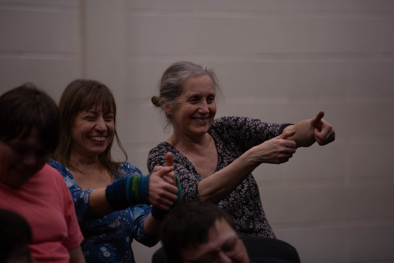 In My Younger Years – rehearsal in the section 'Computer Games': Arlene James, Agnieszka Michalik and Karen Rush. Three women of different ages. Two of them are smiling and making a similar gesture: they extend both hands with thumbs up.